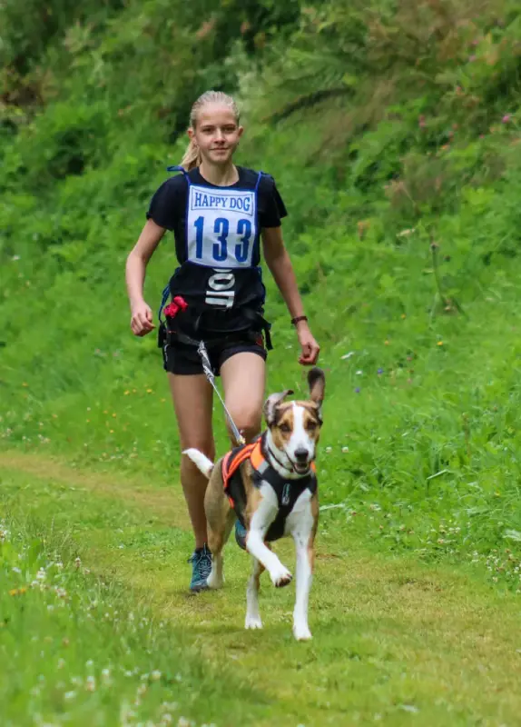 Eine Frau läuft mit einem Hund auf einer Spur. – Jugend und Hund Lager 2020 in Segnas