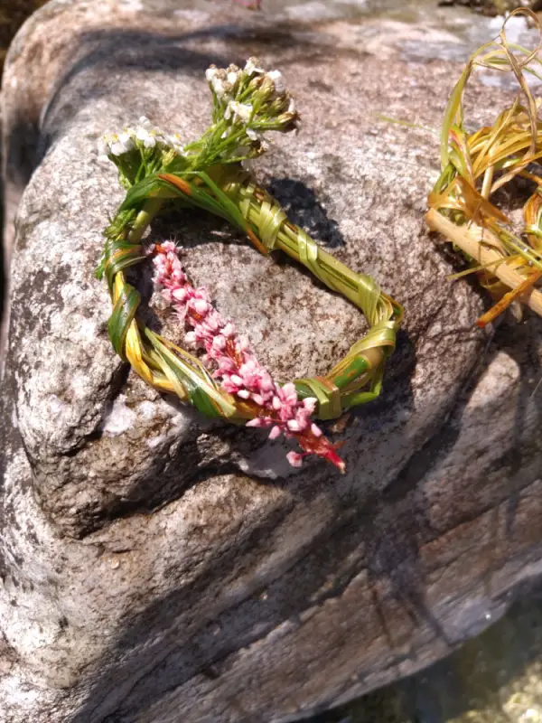 Ein Armband mit Blumen darauf, das auf einem Felsen sitzt. – Jugend und Hund Lager 2021 in Segnas