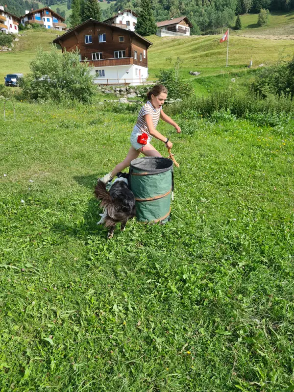 Eine Frau kniet auf einem Grasfeld. – Jugend und Hund Lager 2021 in Segnas