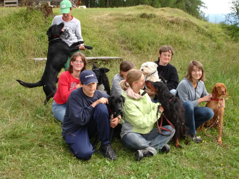 Eine Gruppe von Kindern und einem Hund, der auf einem Hügel sitzt. – Jugend und Hund Lager 2006 in Trans